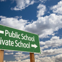 Public or Private School Green Road Sign Over Dramatic Clouds and Sky.