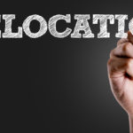 Hand writing the text: Relocation
