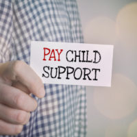 Man showing Pay child support card