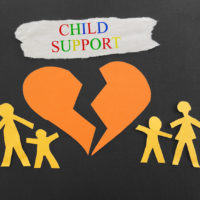 Child Support text with paper family and broken heart