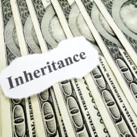 Inheritance note over pile of hundred dollar bills