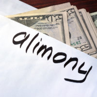 Alimony written on an envelope with cash.