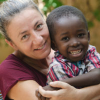 Woman adopts little African boy