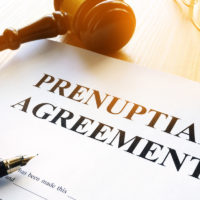 prenup agreement with pen and gavel on table