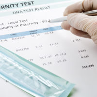 Doctor points at result on paternity test result form