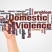 Domestic Violence word cloud and hand with marker concept
