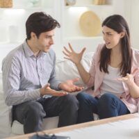 Man and woman having fight in therapy or marriage counseling