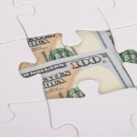 American Banknote Hidden Under Jigsaw