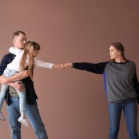 Upset family after divorce against color background