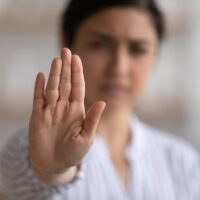 Close up focus on Indian woman showing stop gesture