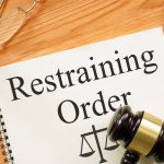 Restraining Order is shown on a photo using the text
