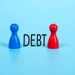 Blue and Red Wooden Board Game Pawns Separated by the Word "DEBT" on a Bright Blue Background