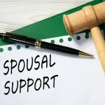 SPOUSAL SUPPORT - words in white paper against the background of a green folder and a judge's gavel